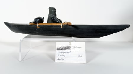 Hunter with Seal in Kayak