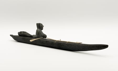Hunter in Kayak with Seal